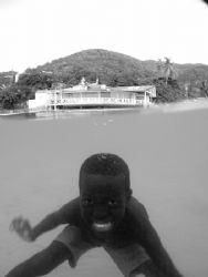 A young BVI Belonger plays underwater for the camera shot... by Terry Moore 